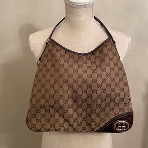 Traditional pattern Gucci handbag with strap.  Fabric inside Dimensions 13x12.